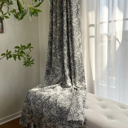 a white couch sitting under a window next to a plant