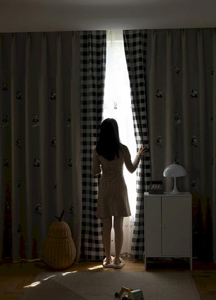 a woman standing in front of a window