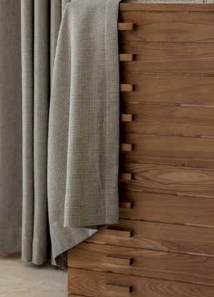 a close up of a bed with a wooden headboard