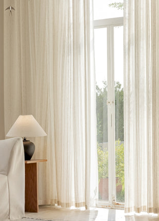 a living room with a white couch and a large window