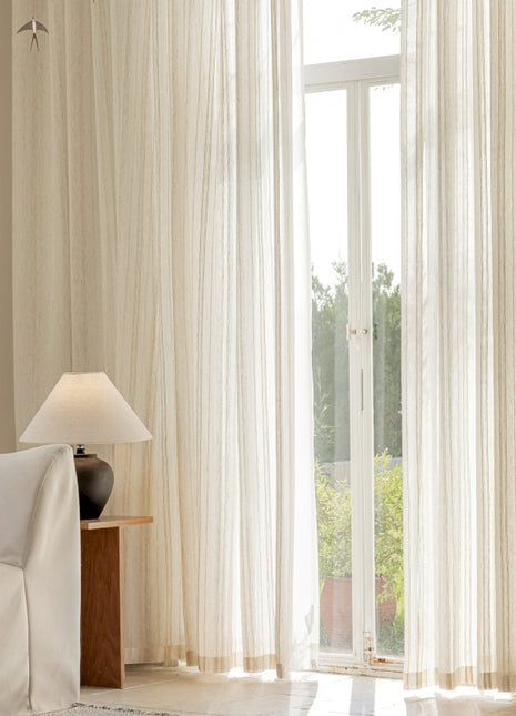 a living room with a white couch and a large window