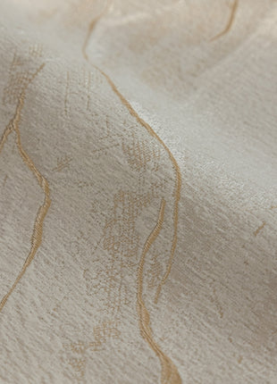 a close up of a white fabric with gold lines