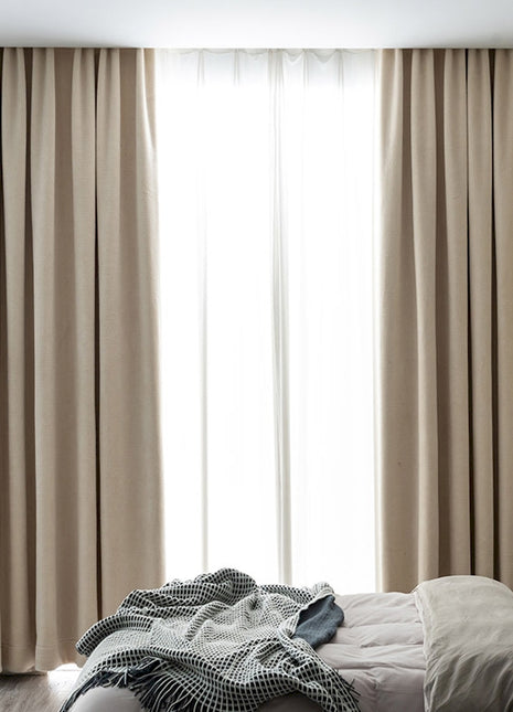 a bed room with a neatly made bed and a large window