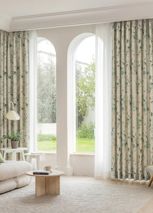 a living room filled with furniture and large windows