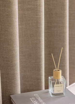 a bottle of perfume sitting on top of a book