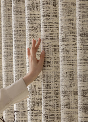 a woman is holding her hand up to a curtain