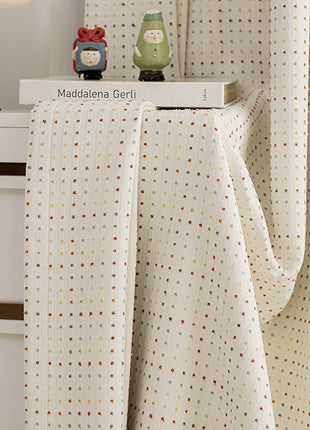 a close up of a bed with a curtain