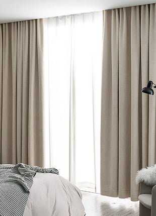 a bed room with a neatly made bed and a large window