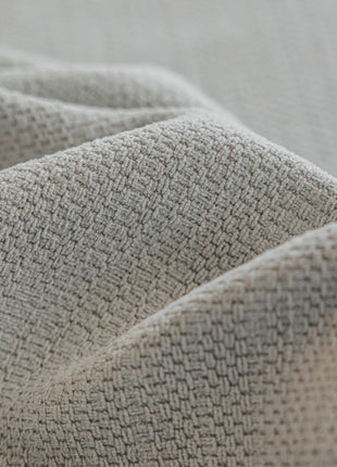 a close up of a bed with a white blanket