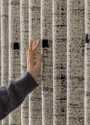 a person reaching out to touch a wall with their hand