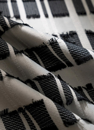 a close up of a black and white checkered fabric