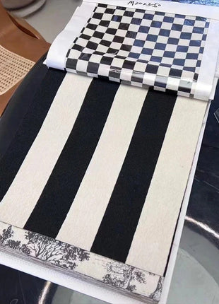 a table with a black and white table runner on top of it