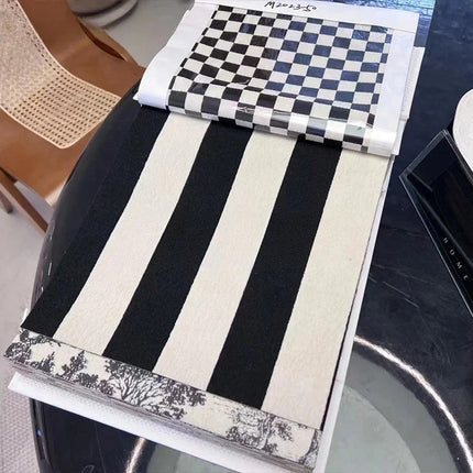 a table with a black and white table runner on top of it