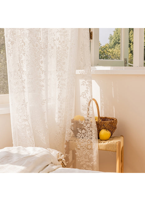 a bedroom with a white bed and a window