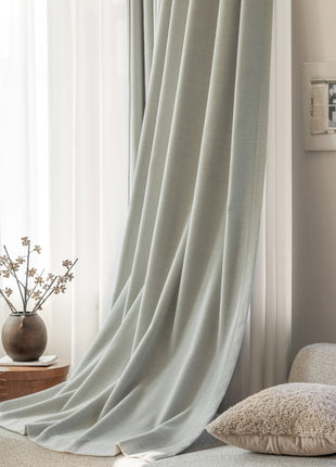 a living room with a couch and a vase with flowers