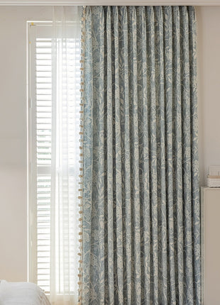 a bedroom with a bed and a window covered in curtains