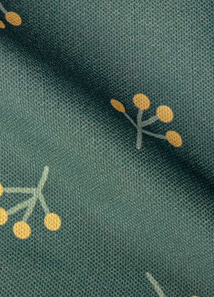 a close up of a green fabric with yellow dots