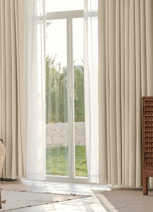 a living room with a couch, chair and sliding glass doors