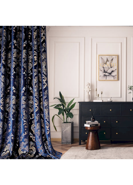 a living room with a black dresser and a blue curtain