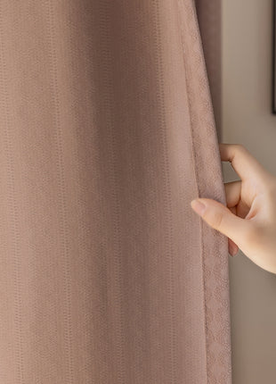 a person holding a curtain with their hand