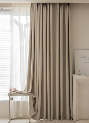 a room with a chair, a table and a window