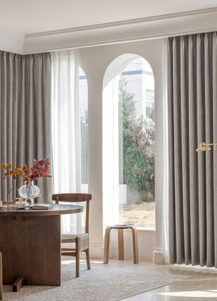 a living room filled with furniture and a large window