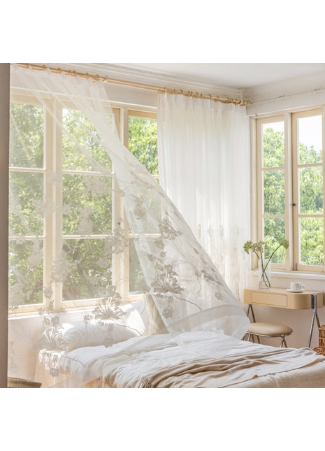 a bed with a white canopy in a bedroom
