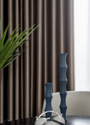 a table with a vase and a plant on it