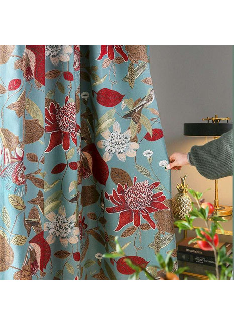 a person is opening a curtain with a flower pattern