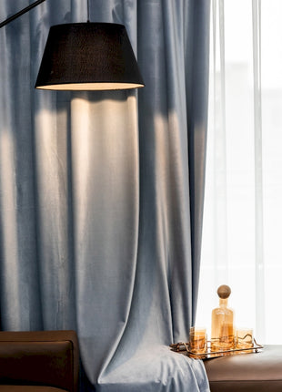 a table with a lamp and a bottle on it