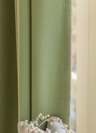 a close up of a window with a curtain