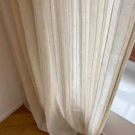 a white curtain hanging on a window sill