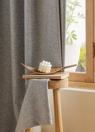 a wooden spoon sitting on top of a table next to a window