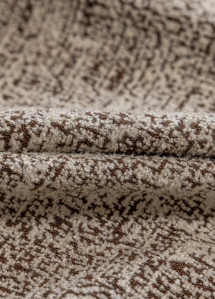 a close up of a brown and white blanket