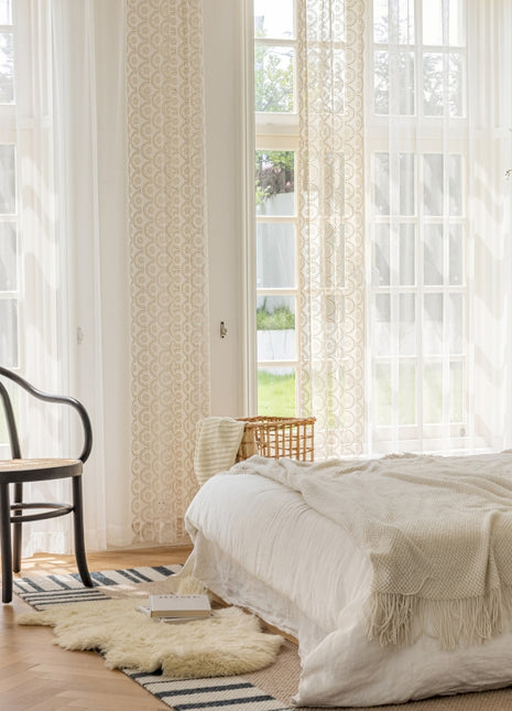 a bedroom with a bed and a chair in it