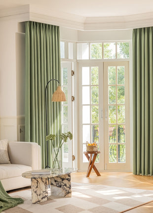 a living room filled with furniture and a large window