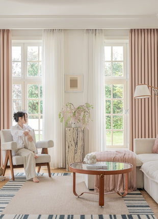 a woman sitting on a couch in a living room
