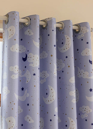 a window with a blue curtain with stars and clouds on it