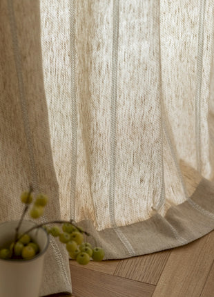 a white vase with some green grapes in it