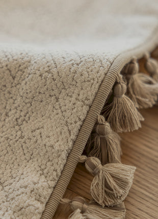 a close up of a blanket on a wooden floor