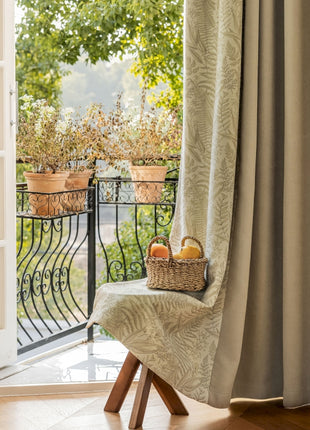 a chair sitting in front of a window with a basket of fruit on it