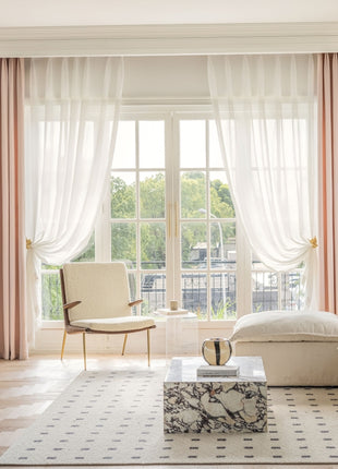 a living room filled with furniture and a large window