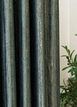 a close up of a curtain with a plant in the background