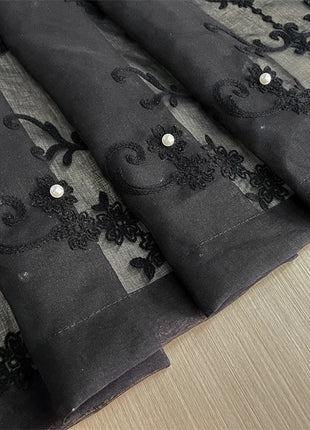 a close up of a piece of cloth with black lace on it