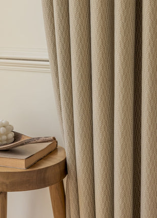 a wooden stool sitting next to a window with a curtain