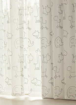 a baby crib next to a window with a curtain