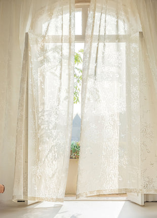 a living room with a chair and a window