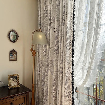 a window with a curtain and a lamp next to it