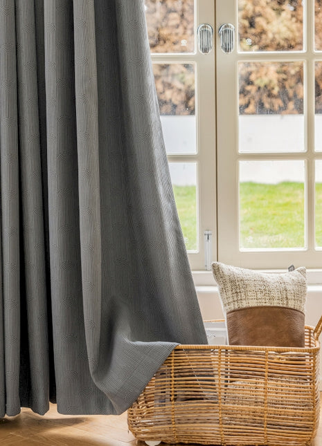 a chair and a basket in front of a window