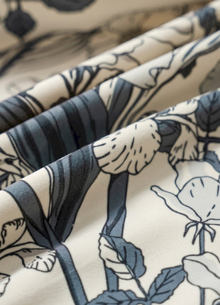 a close up of a flowered fabric with black and white flowers